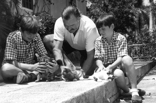 Ernest Hemingway with his sons and cats at Finca Vigia in 1946